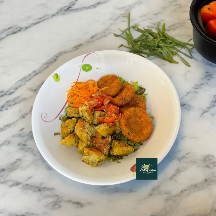 Spicy Butter Dressing Salad with Paneer Cutlets Healthy homemade salad featuring golden paneer cutlets, chickpea coriander bagels, fresh veggies, and a buttery spicy dressing.