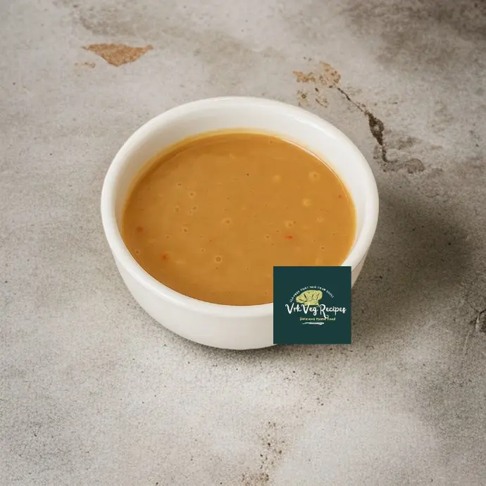 Smooth and tangy peanut ginger salad dressing made with natural ingredients, adding bold taste to any dish.