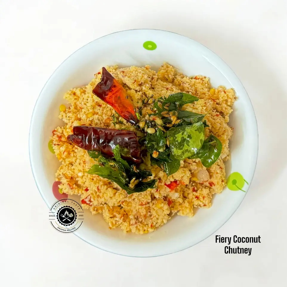 Hot and spicy coconut chutney with red chillies, black pepper, and crispy tempering served in a rustic bowl