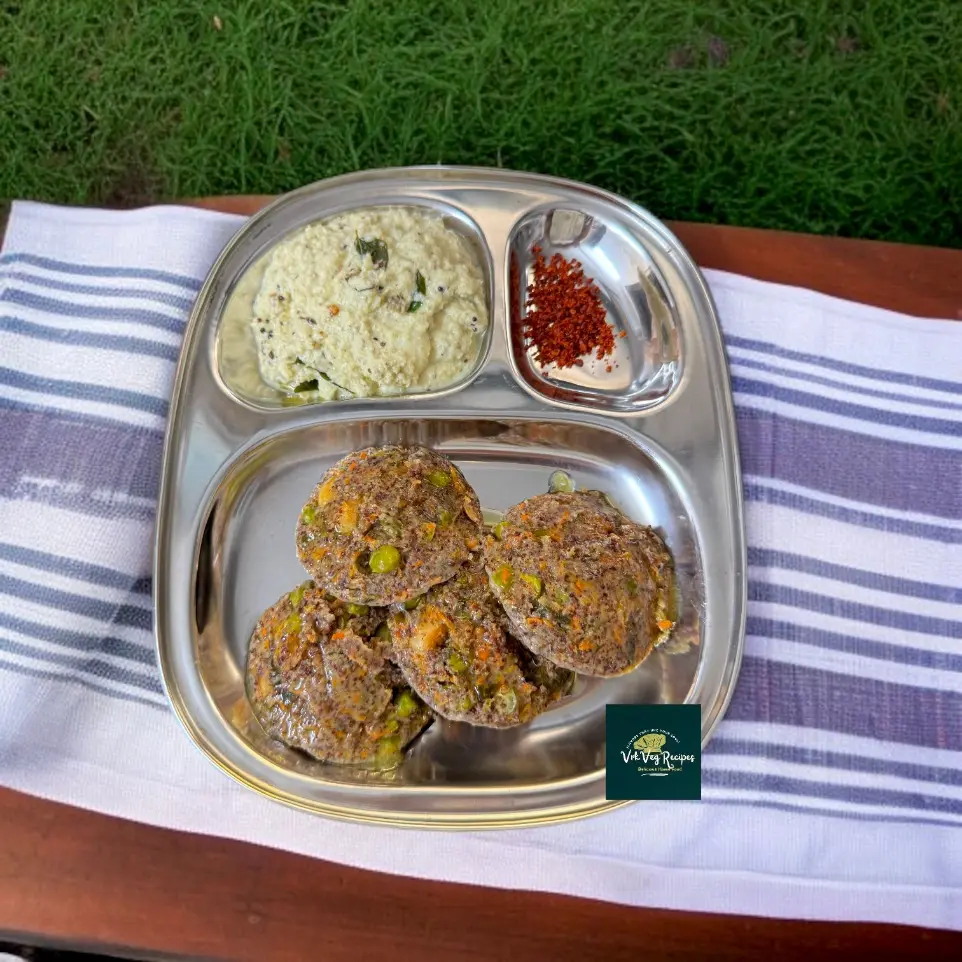Soft and healthy steamed ragi idlis loaded with vegetables, tempered with ghee, mustard, cashews, and served with chutney.