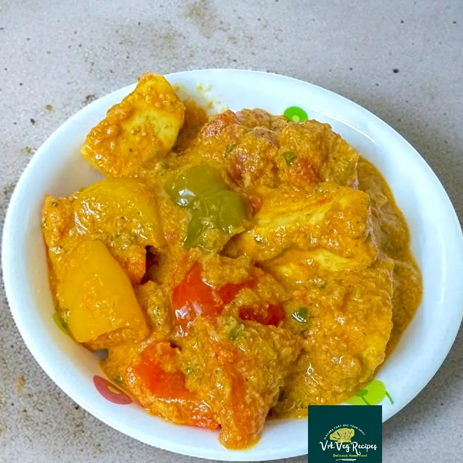 Creamy curry with paneer cubes, colorful capsicum, coconut-onion masala, and mild spices served hot with roti.