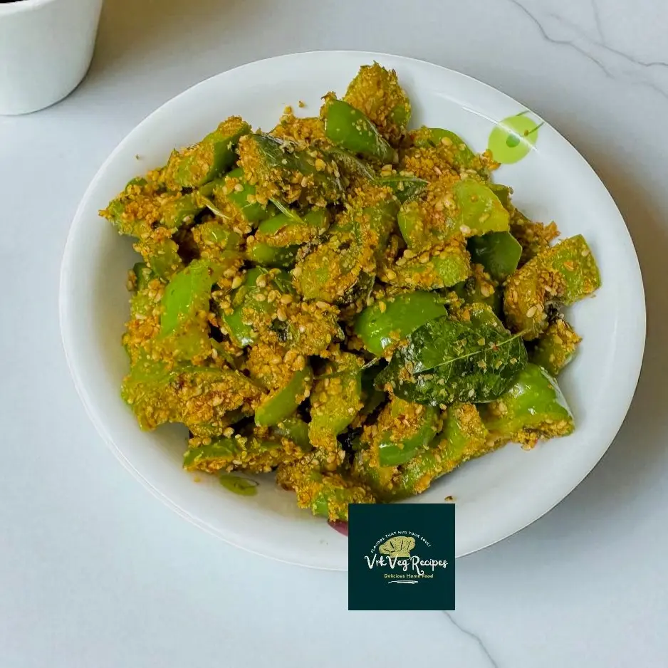 Nutty green capsicum sautéed in aromatic spices with sesame powder and amchur, perfect for Indian lunches.