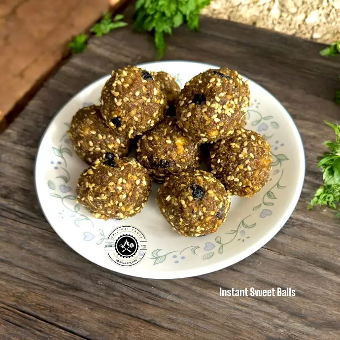 Instant sweet balls made with coconut, paneer, jaggery, nuts, and seeds, coated with sesame seeds for a deliciously healthy festive treat.