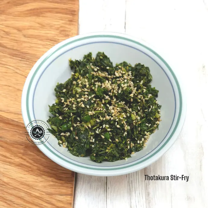 Thotakura stir-fry with sesame, garlic, and chillies served hot as a side dish with rice or roti for a healthy South Indian vegetarian meal.