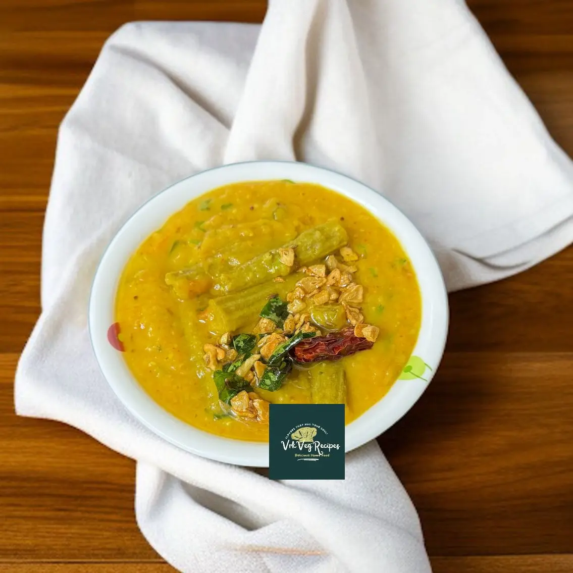 Spicy garlic tadka over creamy toor dal with tender drumsticks—flavorful, aromatic, and perfect for a soulful meal.