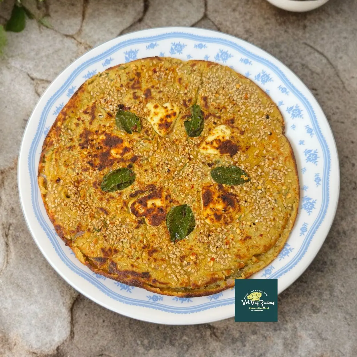 Thick, golden brown chana dal uttapam topped with paneer, sesame, and veggies—roasted on tawa for a no-chutney high-protein snack.