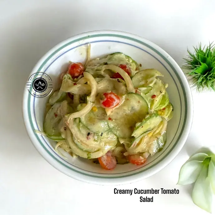 Cool and creamy cucumber tomato salad with curd dressing, perfect for summer hydration and gut-friendly nutrition.