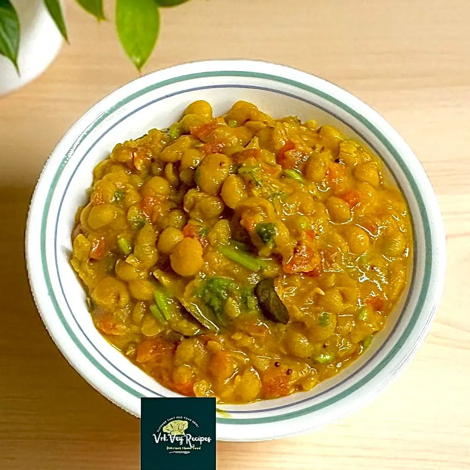 Spicy white peas sambar curry served hot with crispy dosa and garnished with coriander