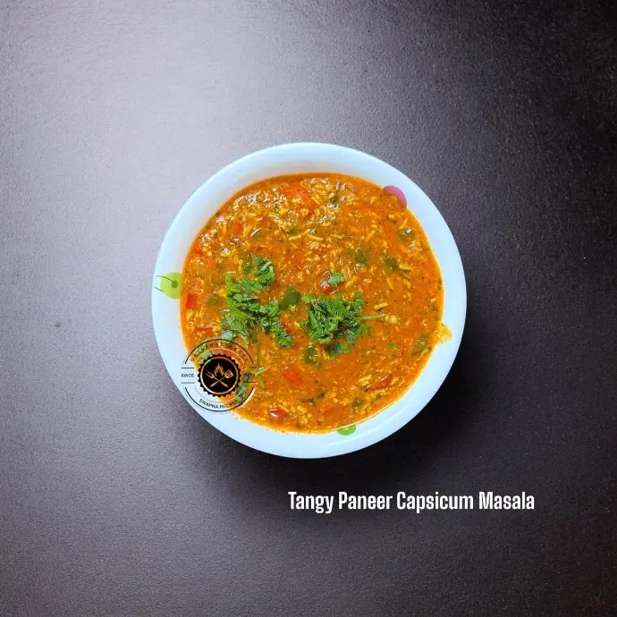 Flavor-packed Tangy Paneer Masala featuring red and green capsicum, soft paneer, and zingy amchoor in a rich, buttery tomato base.