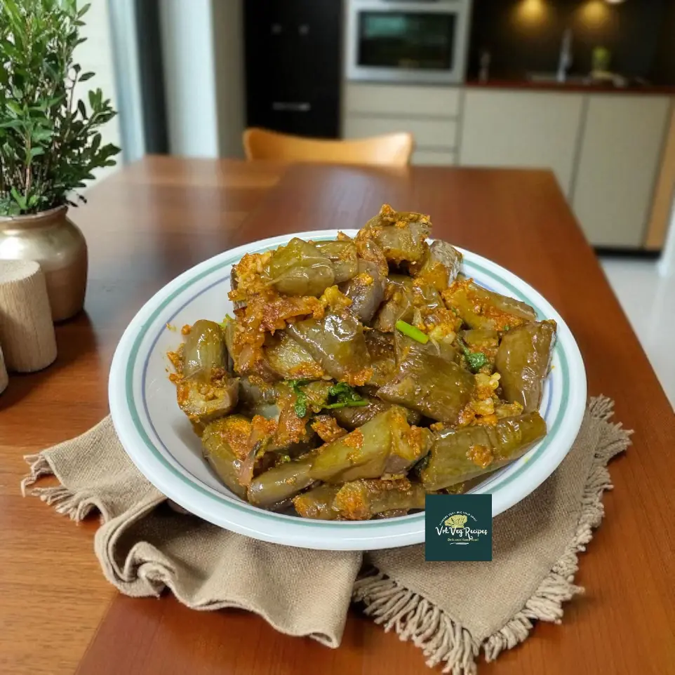 A pan-fried brinjal curry cooked with garlic peanut masala and curry leaves, served hot with roti or rice for a bold and spicy vegetarian meal.