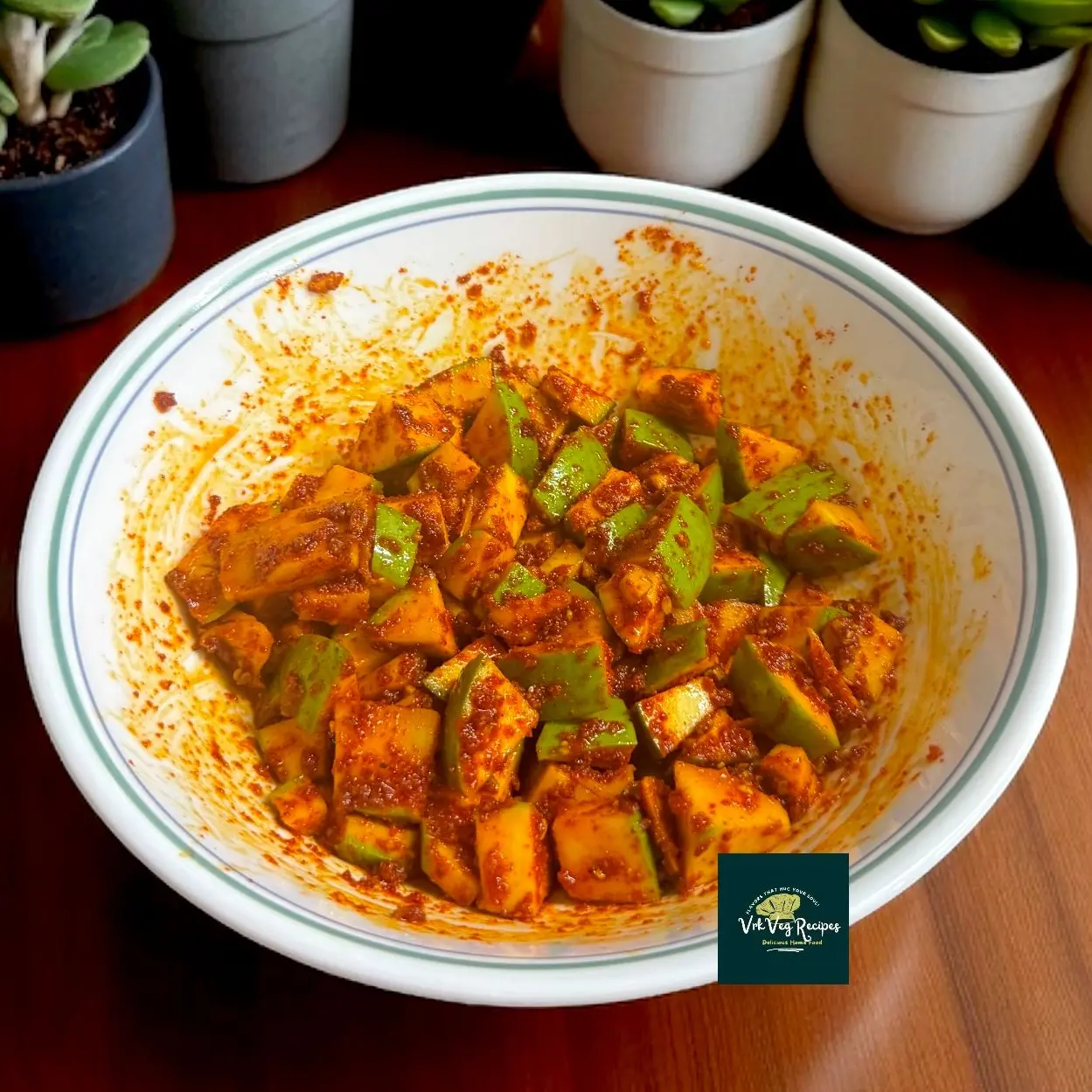 Tangy raw mango pickle marinated with chilli, hing, turmeric, and fenugreek seeds — perfect spicy side for your summer meals.