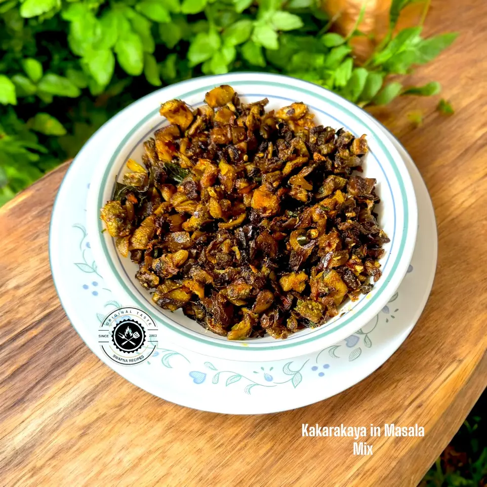 Spicy kakarakaya masala stir-fry with garlic, onions, curry leaves, and dry spice blend served hot with rice for a bold and flavorful Andhra-style meal.