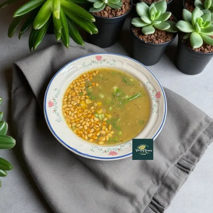 A bowl of thick, creamy drumstick soup topped with spiced paneer, herbs, and seeds – flavorful, protein-rich, and ideal for vegetarians.