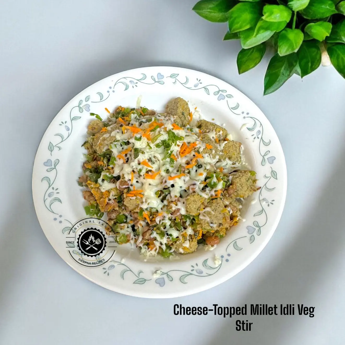 Spicy and cheesy millet idli veg stir made with butter, jeera, veggies, and topped with gooey cheese. Served hot with neer chutney.