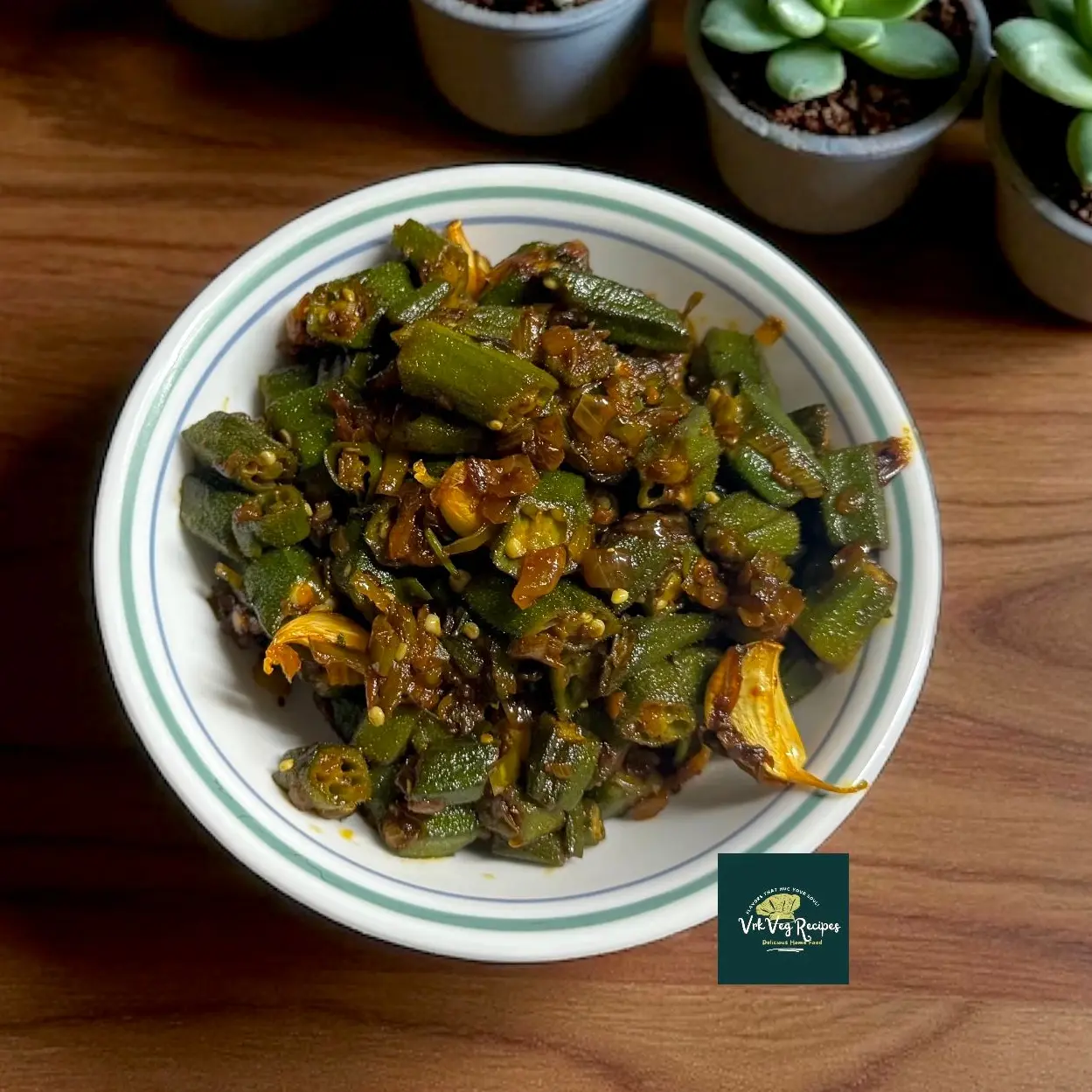 Homestyle Tangy Okra on a platter: sliced bendi mixed with vibrant green chillies, spices and freshly squeezed lemon, showcasing rustic texture and colour.