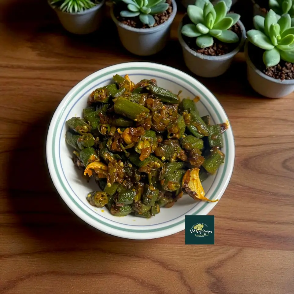 Tangy Spiced Okra Stir-Fry | Quick Bendi Recipe for Lunch Tangy Spiced Okra Stir-Fry on a plate: chopped okra with onions, green chillies and ajwain, cooked in mustard oil, finished with lemon and chopped coriander.