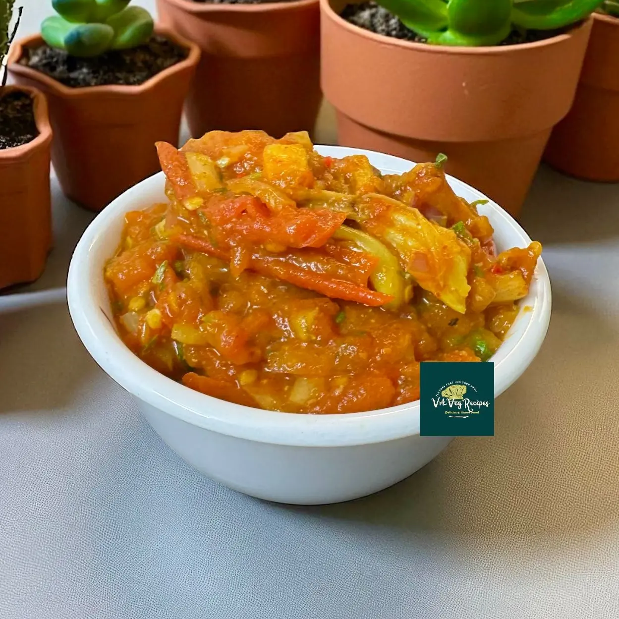 Garlic Tomato Coriander Chutney with onions, spices, and fresh herbs, mashed into a smooth paste for a tangy and spicy side dish.