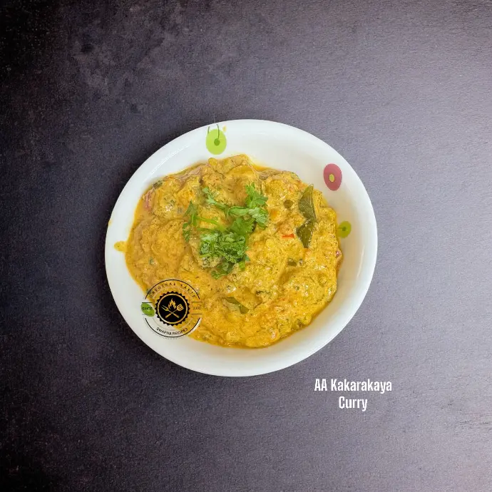 AA Kakarakaya Curry or Spiny Gourd Curry with onion, tomato, kasuri methi, sunflower seed paste, and aromatic Indian spices for a rich meal.