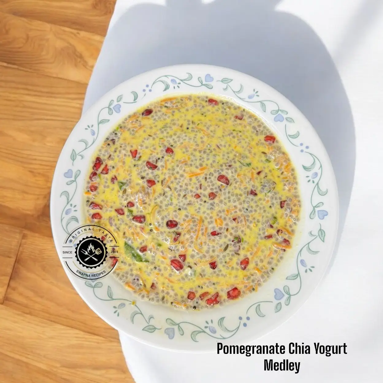 Pomegranate Chia Yogurt Medley: creamy curd with soaked chia, grated carrot, fried cashews, pomegranate arils and coriander, topped with mustard-jeera tadka