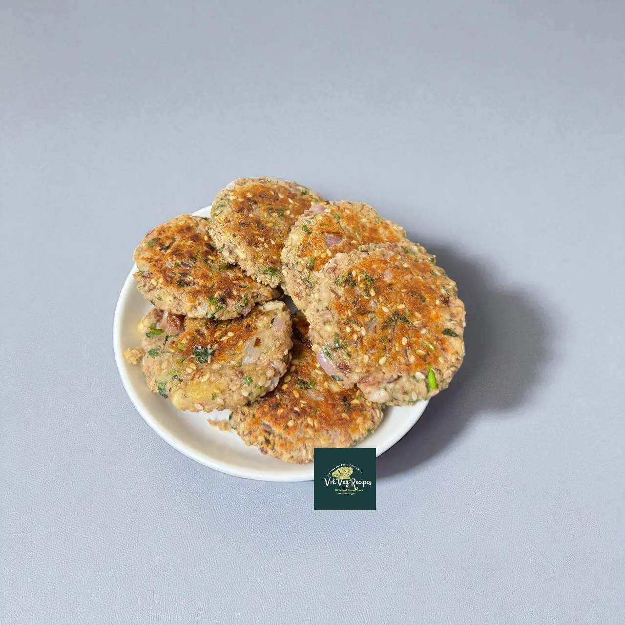Pan-fried Rajma Paneer Patties topped with ghee, served hot with coriander leaves and chutney, protein-rich vegetarian recipe.