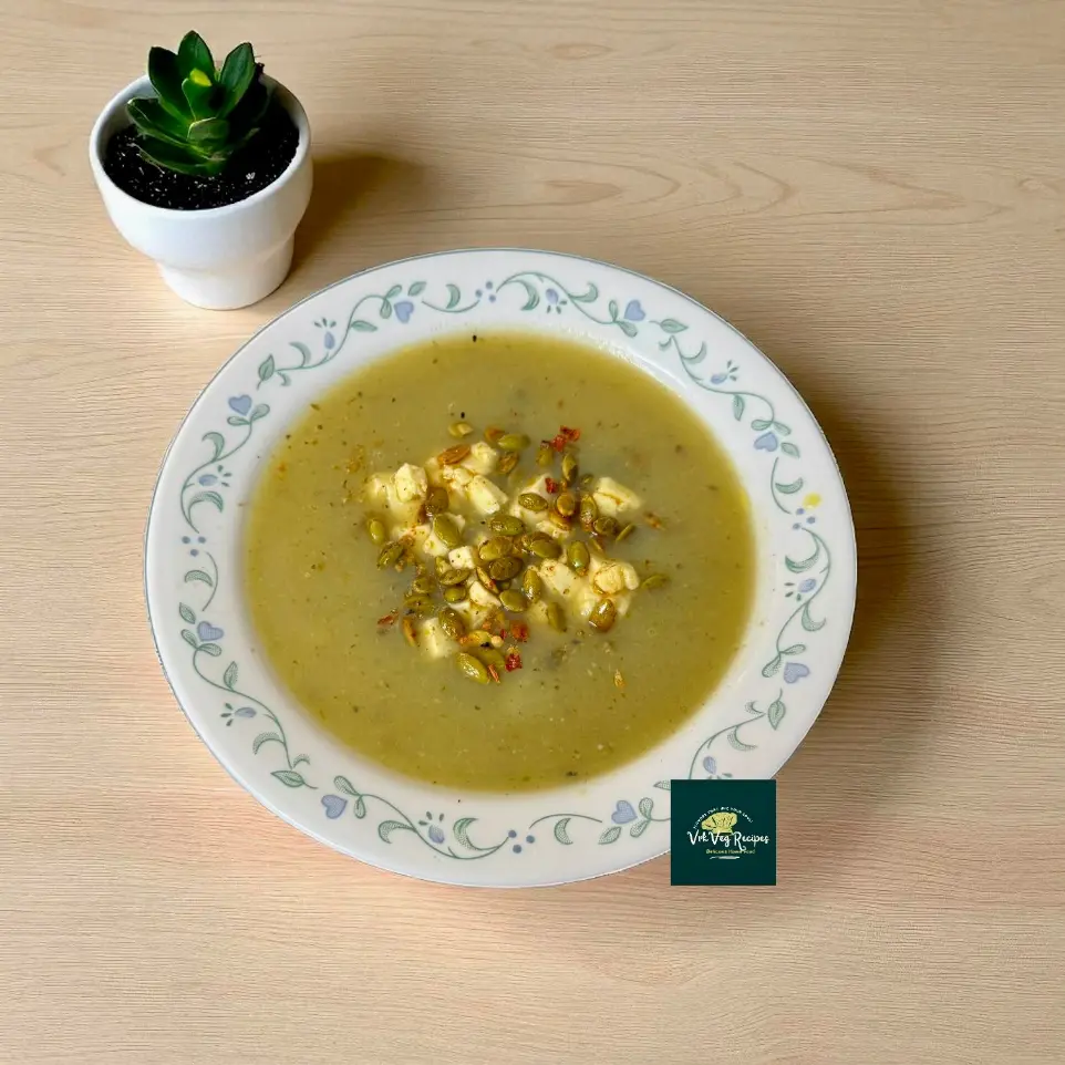 Healthy bottle gourd garlic soup with coriander, paneer toppings, pumpkin seeds, and spices, served warm in a cozy soup bowl.