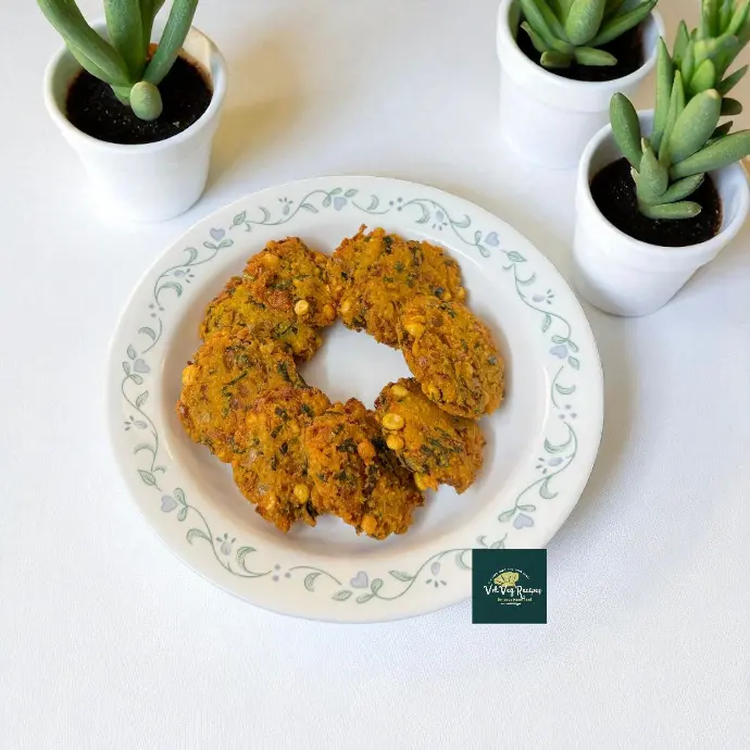 South Indian Channa Dal Vada | Crispy Lentil Fritters Hand-held Channa Dal Vada pressed flat between palms, showing rustic texture, mustard seeds and curry leaf flecks; ready to fry and enjoy with tamarind chutney.