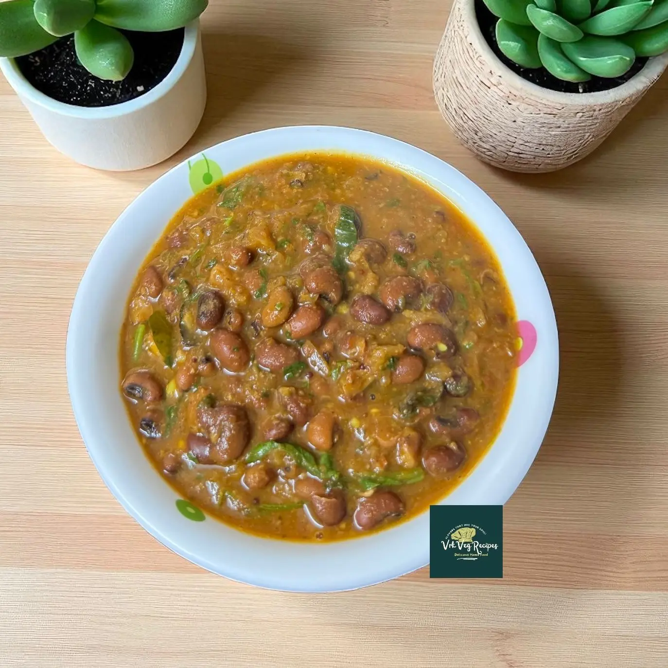 Bowl of Spicy Red Lobia Masala: tender red cowpeas in a glossy tomato-garlic gravy, garnished with fresh coriander and curry leaves, served with rice.