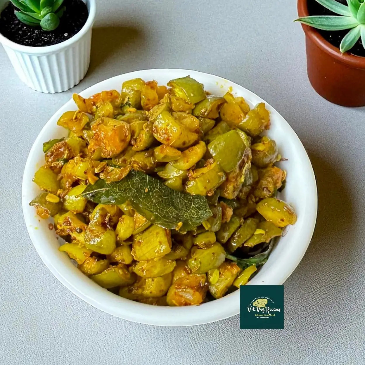 Spicy Garlic Dondakaya Fry — pan-fried ivy gourd with crushed garlic, red chilli, saunf, amchoor, mustard seeds and curry leaves; garnished with coriander.