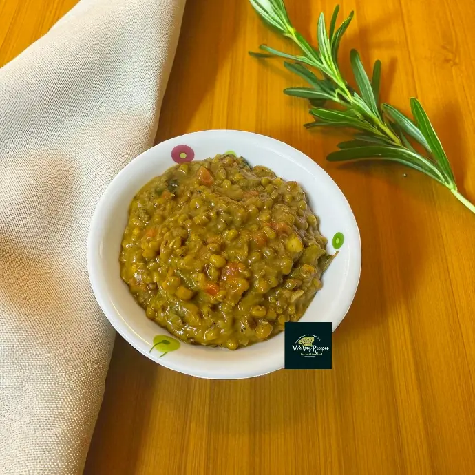 Quick Green Moong Masala Dal — Homestyle Flavor & Tips Top view of creamy green moong dal masala with tomato bits, crushed garlic and coriander, served beside hot steamed rice for a homely meal.