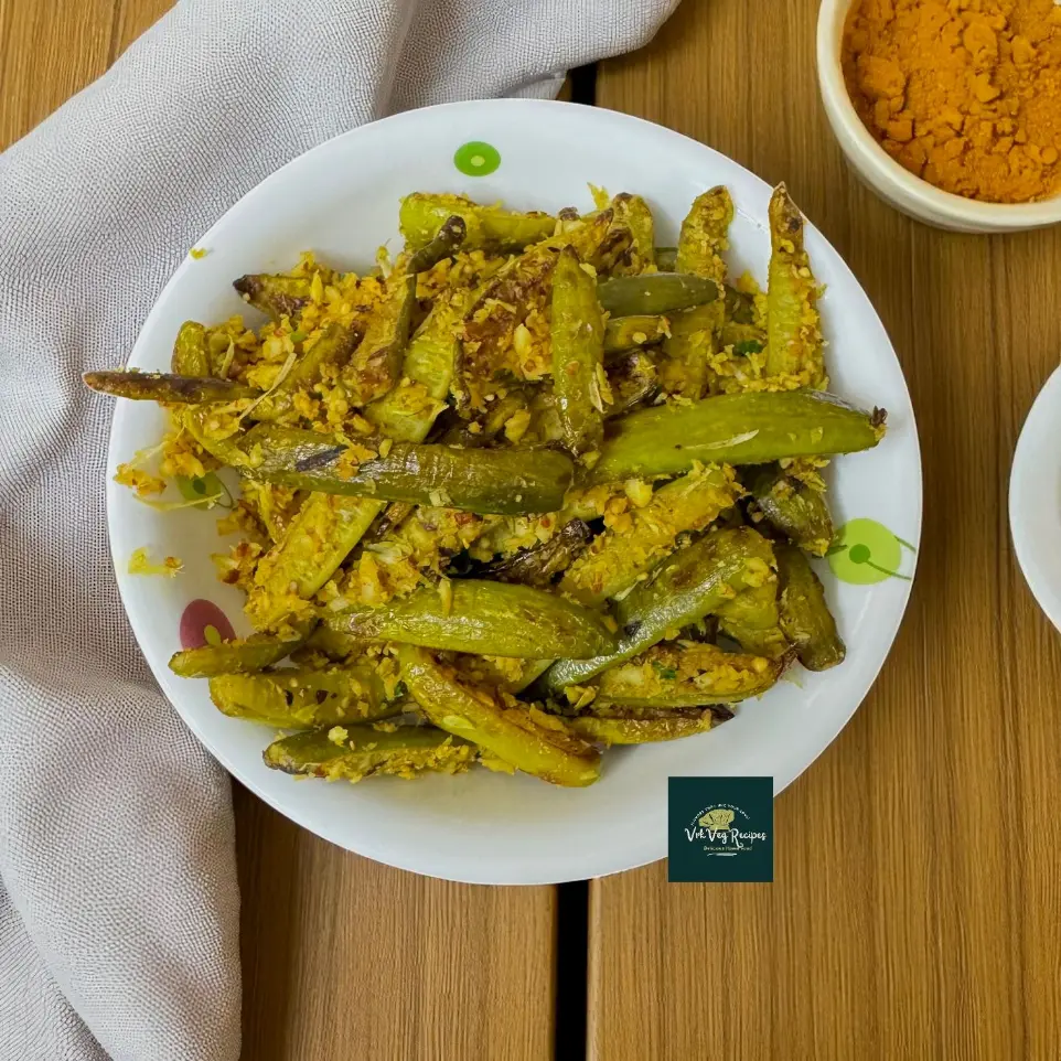 Delicious spicy Fried Dondakaya Coconut Masala served in a bowl, garnished with fresh coriander and a golden coconut garlic masala coating.